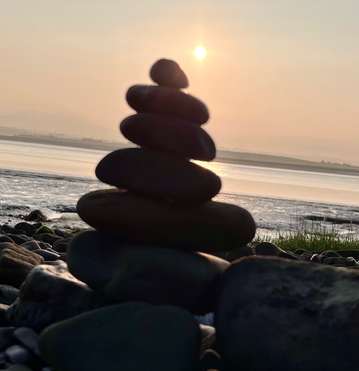 Balanced stones cairn at Sunderland Point at sunset